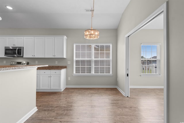 347 Leste Rd, Myrtle Beach, SC 29588 - kitchen featuring appliances with stainless steel finishes, light wood-type flooring, a chandelier, white cabinetry, and vaulted ceiling