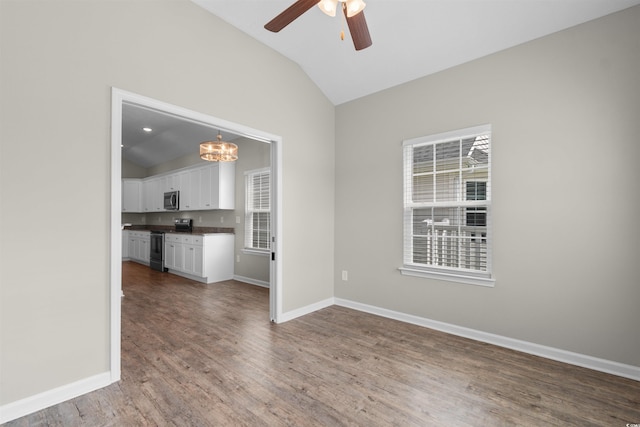 347 Leste Rd, Myrtle Beach, SC 29588 - unfurnished living room with vaulted ceiling, ceiling fan, wood finished floors, healthy amount of natural light, and a chandelier