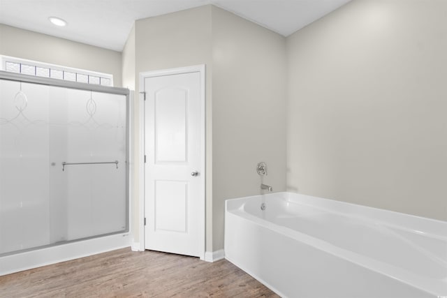 347 Leste Rd, Myrtle Beach, SC 29588 - bathroom featuring wood finished floors, a garden tub, and a stall shower