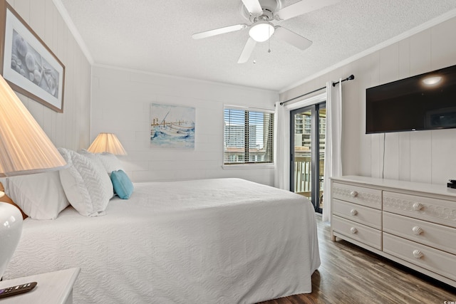 5601 N Ocean Blvd Unit B-314, Myrtle Beach, SC 29577 - bedroom featuring ornamental molding, a textured ceiling, access to exterior, dark wood-style flooring, and ceiling fan