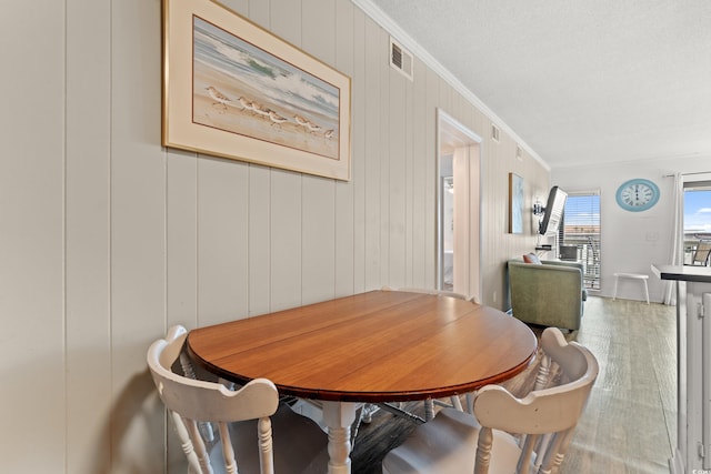5601 N Ocean Blvd Unit B-314, Myrtle Beach, SC 29577 - dining space featuring crown molding and wood finished floors
