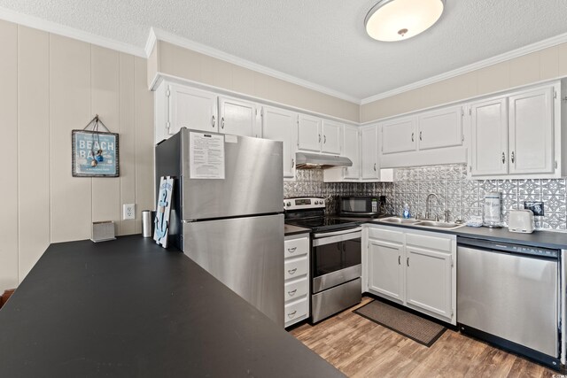 5601 N Ocean Blvd Unit B-314, Myrtle Beach, SC 29577 - kitchen featuring appliances with stainless steel finishes, ornamental molding, dark countertops, under cabinet range hood, and backsplash