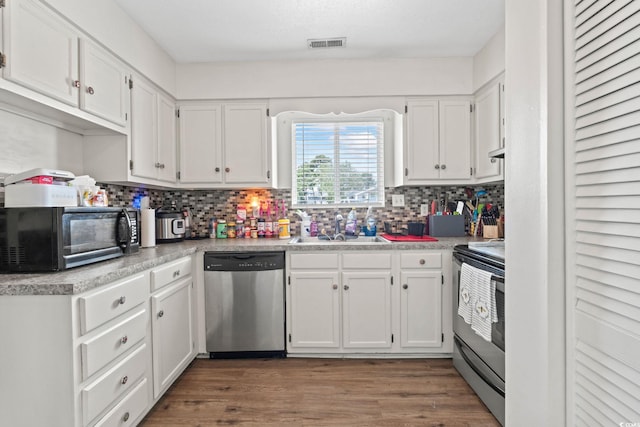 1311 Turkey Ridge Rd Unit A, Surfside Beach, SC 29575 - kitchen featuring appliances with stainless steel finishes, white cabinets, tasteful backsplash, and light countertops