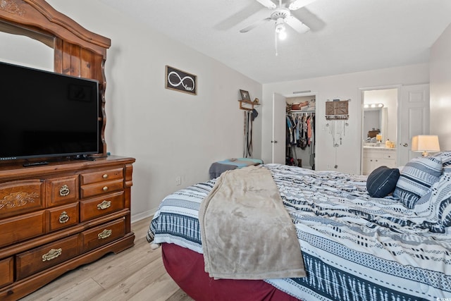 1311 Turkey Ridge Rd Unit A, Surfside Beach, SC 29575 - bedroom with light wood finished floors, a closet, a walk in closet, connected bathroom, and ceiling fan