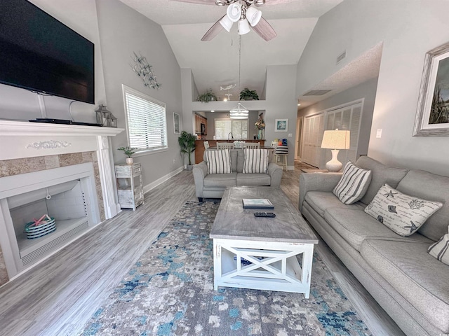 145 Hartland Dr Unit 4-E, Myrtle Beach, SC 29572 - living area with ceiling fan, a tiled fireplace, high vaulted ceiling, and wood finished floors
