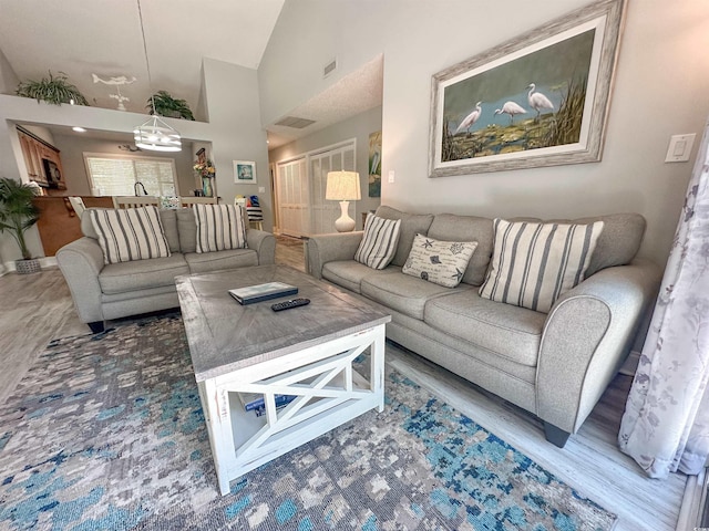 145 Hartland Dr Unit 4-E, Myrtle Beach, SC 29572 - living room featuring wood finished floors, a chandelier, and high vaulted ceiling