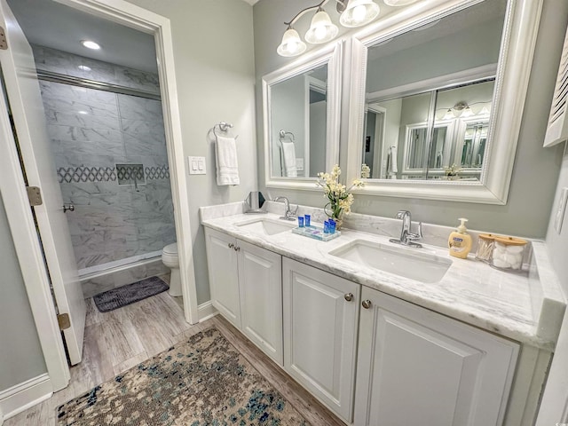 145 Hartland Dr Unit 4-E, Myrtle Beach, SC 29572 - bathroom with a marble finish shower, double vanity, and wood finished floors