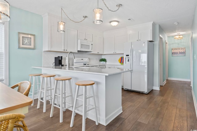 4105 S Ocean Blvd Unit 102, North Myrtle Beach, SC 29582 - kitchen featuring white appliances, white cabinetry, a peninsula, light countertops, and backsplash