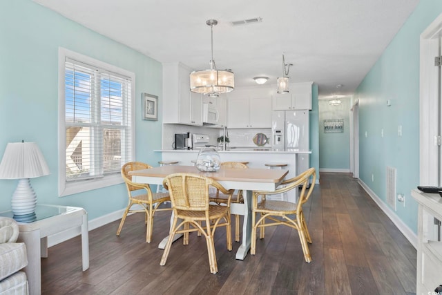 4105 S Ocean Blvd Unit 102, North Myrtle Beach, SC 29582 - dining room with a chandelier and dark wood finished floors