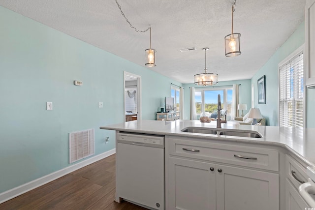 4105 S Ocean Blvd Unit 102, North Myrtle Beach, SC 29582 - kitchen with white dishwasher, a textured ceiling, dark wood-type flooring, light countertops, and hanging light fixtures