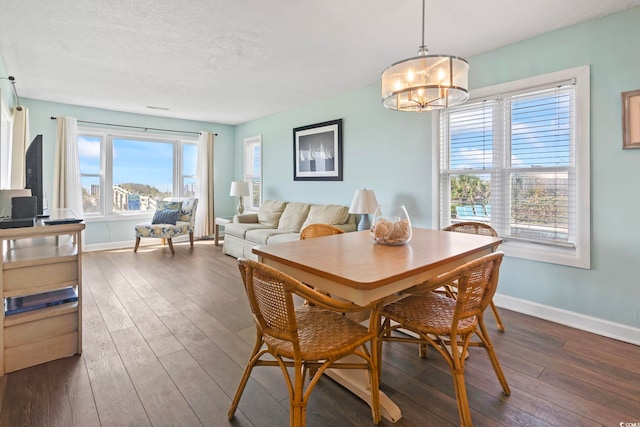 4105 S Ocean Blvd Unit 102, North Myrtle Beach, SC 29582 - dining room with dark wood-type flooring, a chandelier, and a textured ceiling