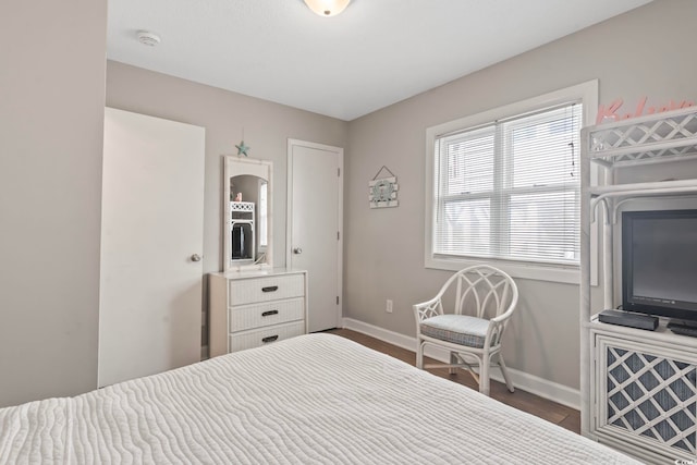 4105 S Ocean Blvd Unit 102, North Myrtle Beach, SC 29582 - bedroom with baseboards and dark wood-type flooring