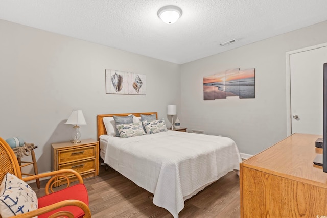 4105 S Ocean Blvd Unit 102, North Myrtle Beach, SC 29582 - bedroom with wood finished floors and a textured ceiling