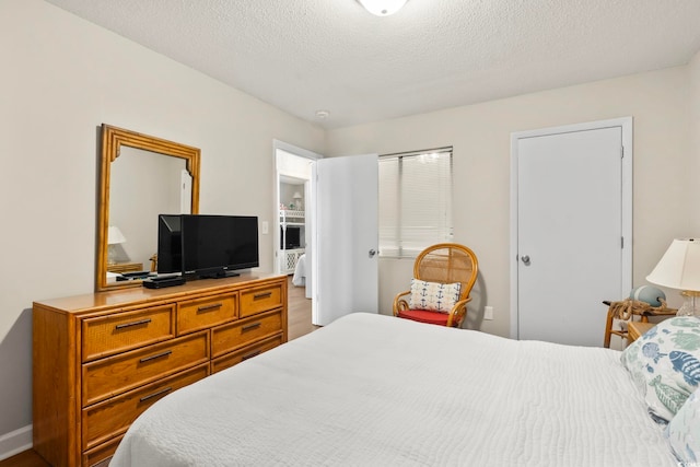 4105 S Ocean Blvd Unit 102, North Myrtle Beach, SC 29582 - bedroom with a textured ceiling and baseboards