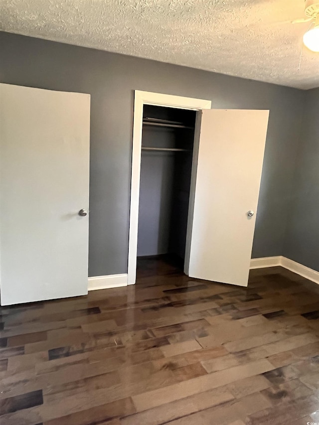 3110 Pinewood Dr, Loris, SC 29569 - unfurnished bedroom featuring dark wood-style floors, a closet, and a textured ceiling