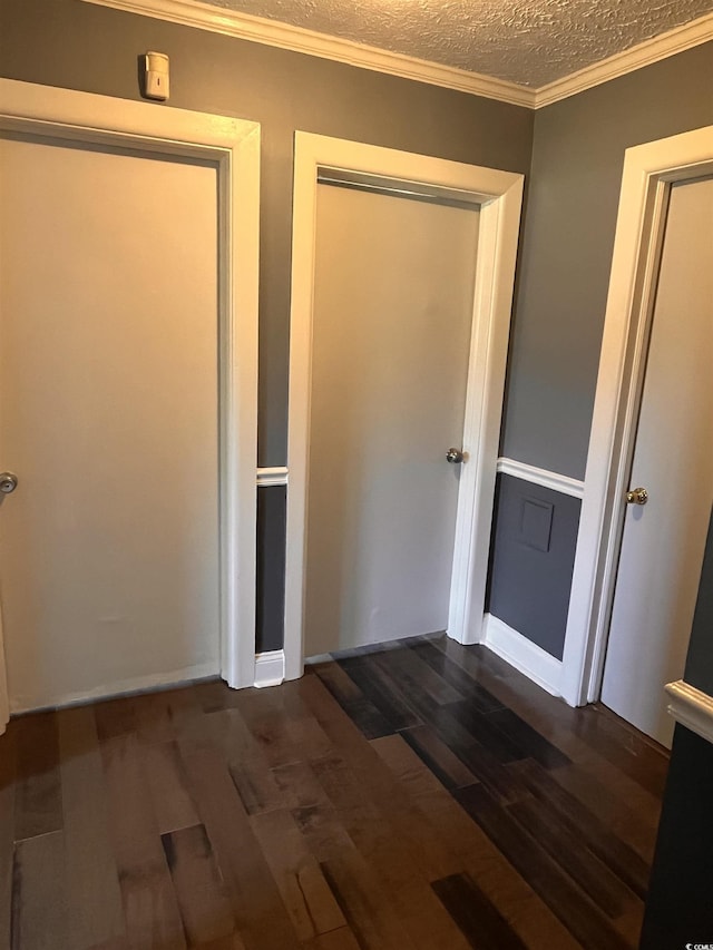 3110 Pinewood Dr, Loris, SC 29569 - unfurnished bedroom with dark wood-style flooring, crown molding, and a textured ceiling