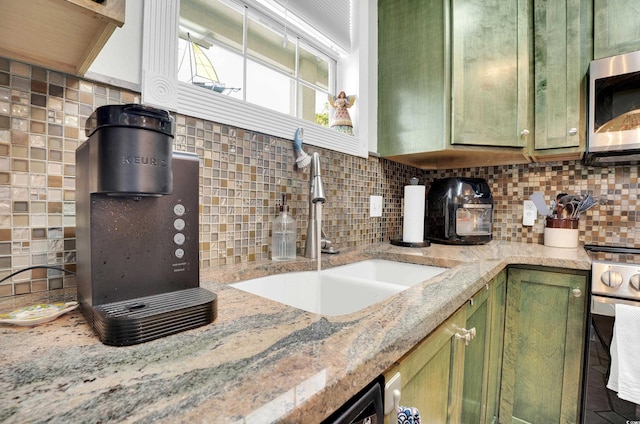 4221 Hibiscus Dr Unit 8-203, Little River, SC 29566 - kitchen featuring green cabinets, appliances with stainless steel finishes, and backsplash
