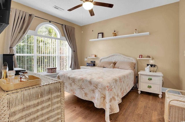 4221 Hibiscus Dr Unit 8-203, Little River, SC 29566 - bedroom featuring wood finished floors, a ceiling fan, and access to exterior