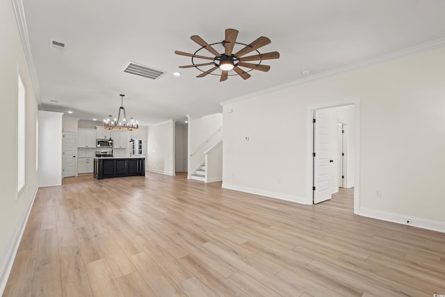 1718 26th Ave N, North Myrtle Beach, SC 29582 - unfurnished living room with a chandelier, ceiling fan, recessed lighting, ornamental molding, and stairs