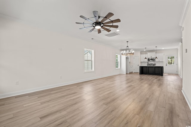 1718 26th Ave N, North Myrtle Beach, SC 29582 - unfurnished living room featuring a chandelier, a ceiling fan, recessed lighting, light wood-style floors, and healthy amount of natural light