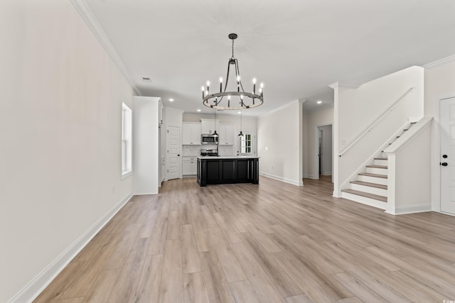 1718 26th Ave N, North Myrtle Beach, SC 29582 - kitchen with a chandelier, open floor plan, crown molding, stainless steel microwave, and healthy amount of natural light