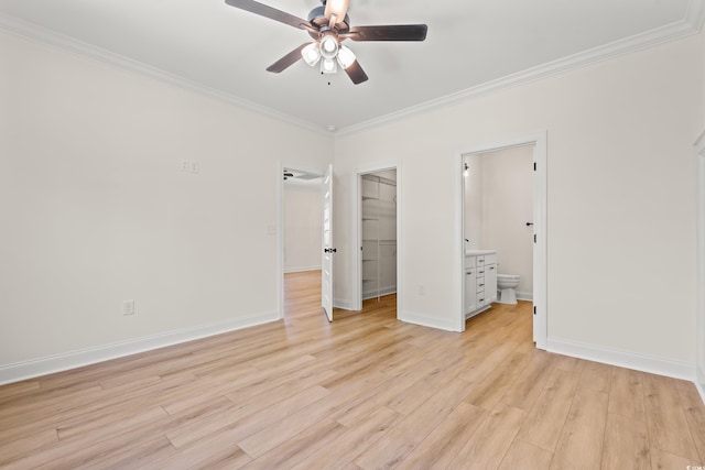 1718 26th Ave N, North Myrtle Beach, SC 29582 - unfurnished bedroom featuring crown molding, a walk in closet, light wood-type flooring, a closet, and ensuite bath
