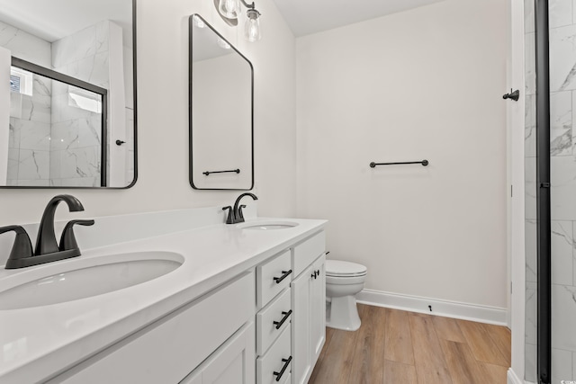 1718 26th Ave N, North Myrtle Beach, SC 29582 - bathroom with a marble finish shower, double vanity, and wood finished floors