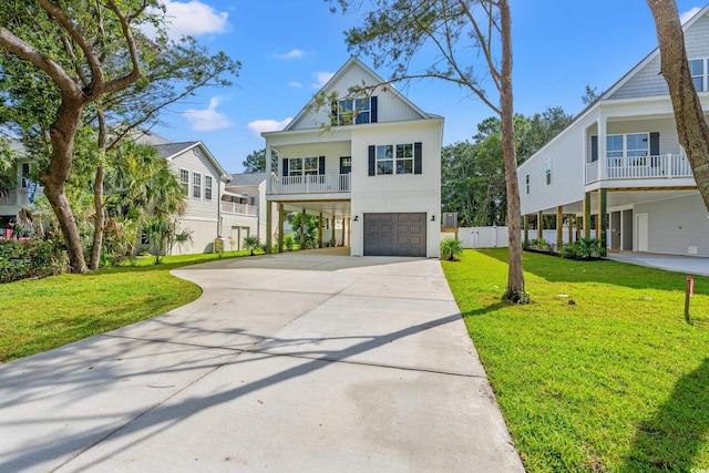 1718 26th Ave N, North Myrtle Beach, SC 29582 - coastal home featuring a garage, concrete driveway, a front yard, and a balcony