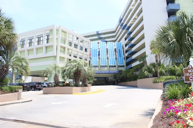 1105 S Ocean Blvd Unit 218, Myrtle Beach, SC 29577 - view of building exterior with uncovered parking