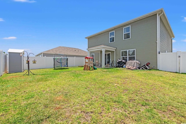 190 Belmonte Dr, Myrtle Beach, SC 29588 - back of property with a trampoline, a playground, and a fenced backyard