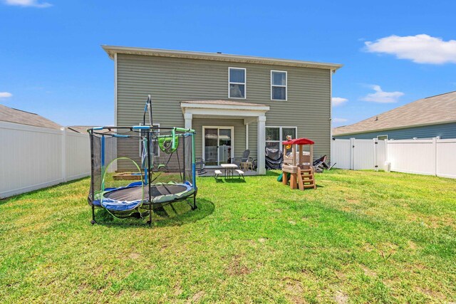 190 Belmonte Dr, Myrtle Beach, SC 29588 - back of house with a trampoline and a fenced backyard
