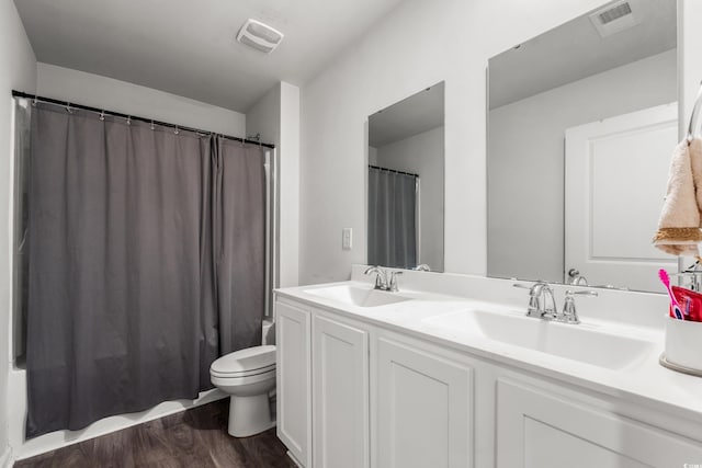 190 Belmonte Dr, Myrtle Beach, SC 29588 - bathroom featuring double vanity, wood finished floors, and shower / bath combo with shower curtain