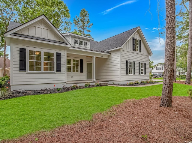 19 Coventry Pl, Pawleys Island, SC 29585 - view of front of property featuring board and batten siding, covered porch, and a front yard