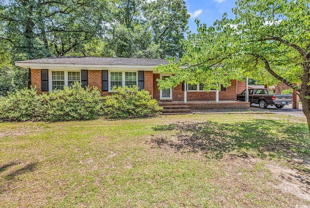 823 Bellamy Ave, Murrells Inlet, SC 29576 - ranch-style home with brick siding, a front lawn, and an attached carport