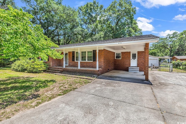 823 Bellamy Ave, Murrells Inlet, SC 29576 - ranch-style house with concrete driveway, entry steps, brick siding, an attached carport, and covered porch