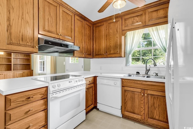 823 Bellamy Ave, Murrells Inlet, SC 29576 - kitchen featuring white appliances, extractor fan, a peninsula, brown cabinets, and light countertops