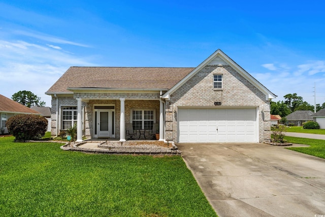 4162 Dupree Dr, Little River, SC 29566 - view of front facade with covered porch, brick siding, a front yard, and concrete driveway