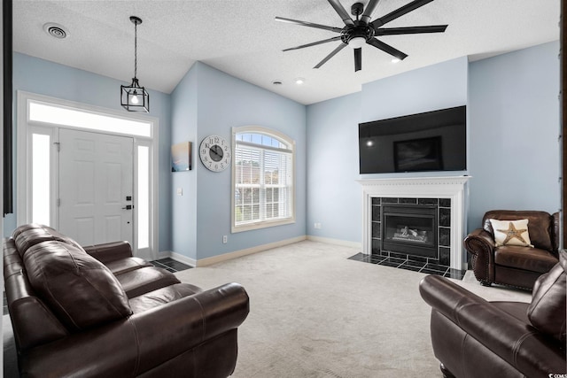 4162 Dupree Dr, Little River, SC 29566 - carpeted living area with a ceiling fan, a tile fireplace, a textured ceiling, and lofted ceiling