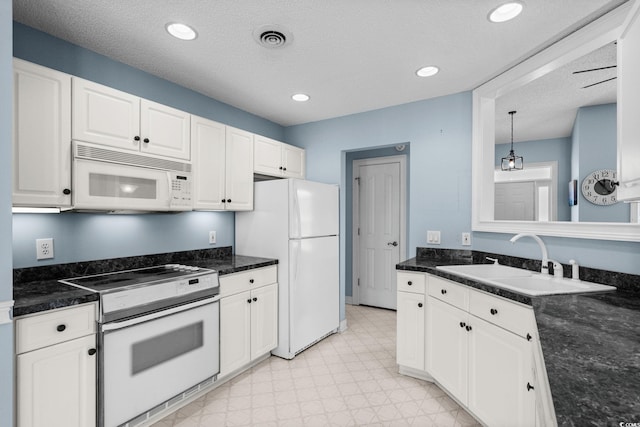 4162 Dupree Dr, Little River, SC 29566 - kitchen featuring white appliances, light floors, white cabinets, hanging light fixtures, and recessed lighting