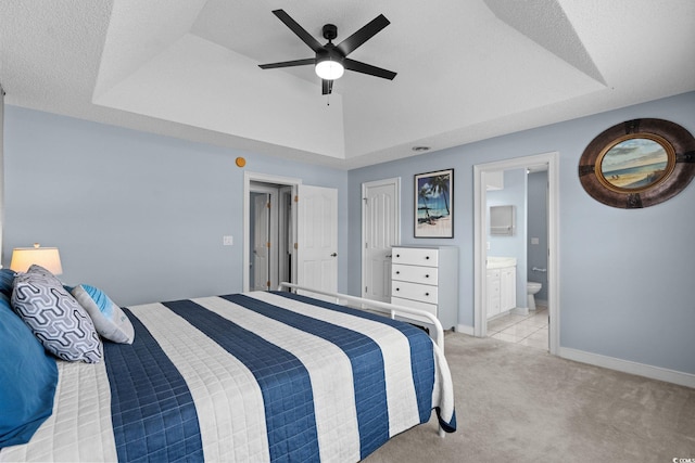 4162 Dupree Dr, Little River, SC 29566 - bedroom with light carpet, a raised ceiling, ensuite bath, and a ceiling fan