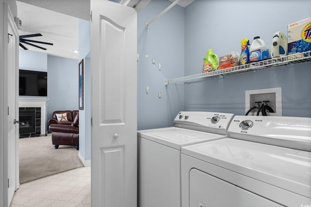 4162 Dupree Dr, Little River, SC 29566 - washroom with separate washer and dryer, light floors, a tile fireplace, a ceiling fan, and light colored carpet