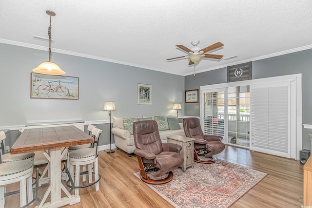 4173 Hibiscus Dr Unit 103, Little River, SC 29566 - living area featuring ceiling fan, light wood finished floors, crown molding, and a textured ceiling