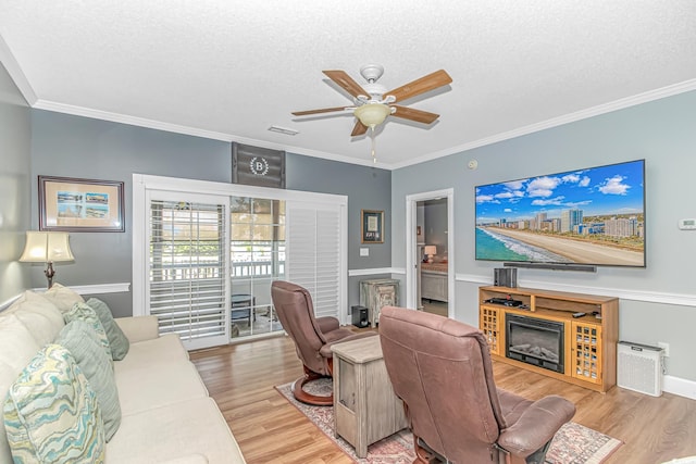 4173 Hibiscus Dr Unit 103, Little River, SC 29566 - living room with wood finished floors, a ceiling fan, ornamental molding, a textured ceiling, and an office area