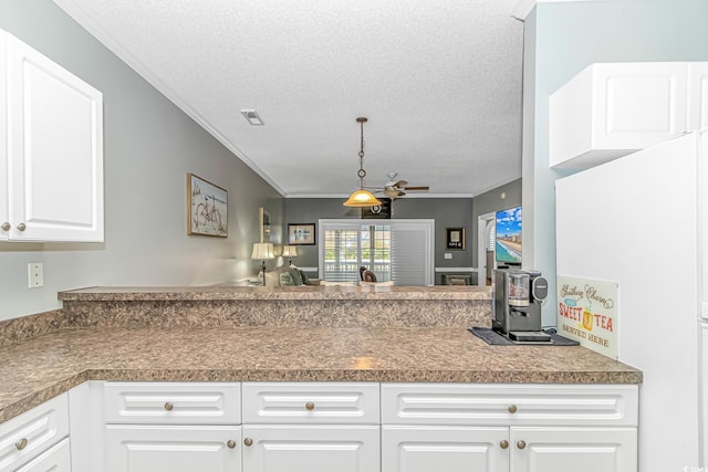 4173 Hibiscus Dr Unit 103, Little River, SC 29566 - kitchen featuring freestanding refrigerator, a textured ceiling, ornamental molding, white cabinets, and ceiling fan