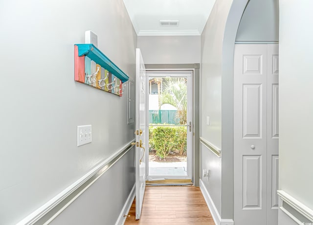 4173 Hibiscus Dr Unit 103, Little River, SC 29566 - doorway to outside featuring arched walkways, wood finished floors, and crown molding