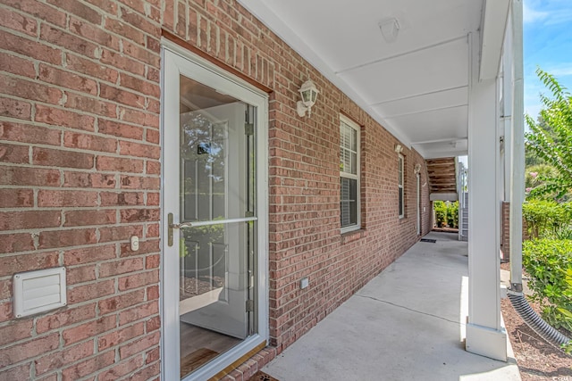 4173 Hibiscus Dr Unit 103, Little River, SC 29566 - doorway to property featuring brick siding and covered porch