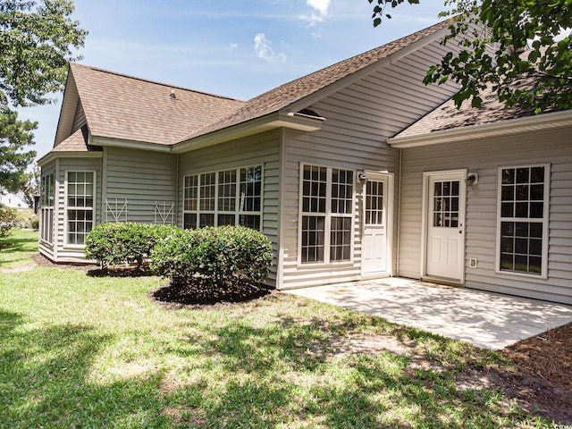 1409 Ashwood Cir, Surfside Beach, SC 29575 - back of property featuring a patio, a shingled roof, and a yard