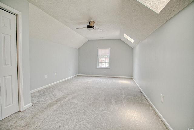1409 Ashwood Cir, Surfside Beach, SC 29575 - additional living space featuring a skylight, ceiling fan, carpet floors, a textured ceiling, and vaulted ceiling