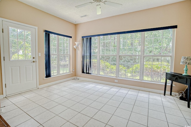 1409 Ashwood Cir, Surfside Beach, SC 29575 - foyer entrance featuring a textured ceiling, a ceiling fan, and light tile patterned flooring