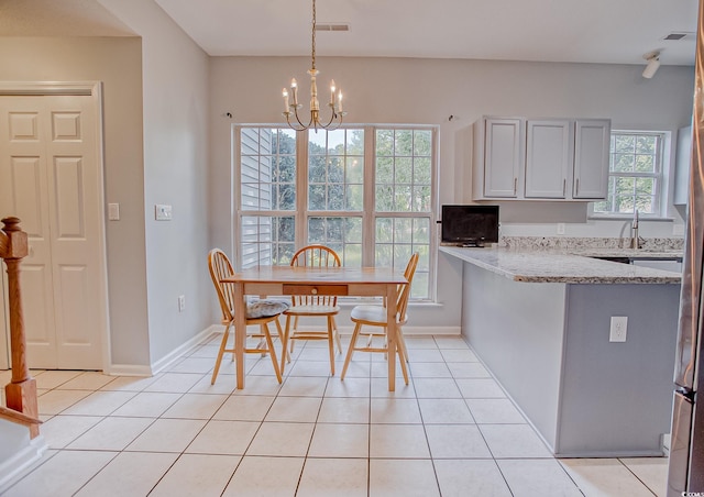 1409 Ashwood Cir, Surfside Beach, SC 29575 - dining area with light tile patterned floors and a chandelier